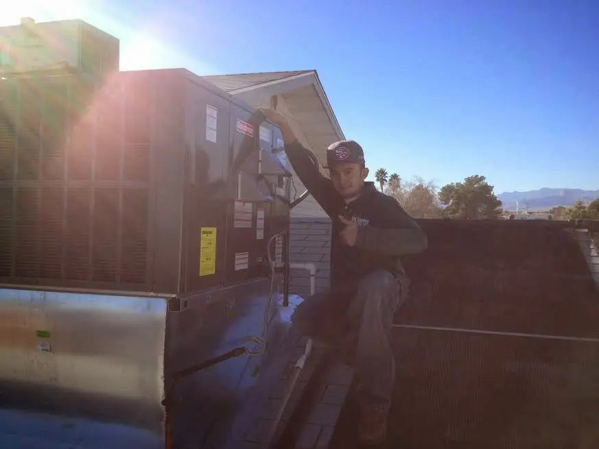 HVAC technician performing Air Duct Repair on a rooftop unit in Ellensburg